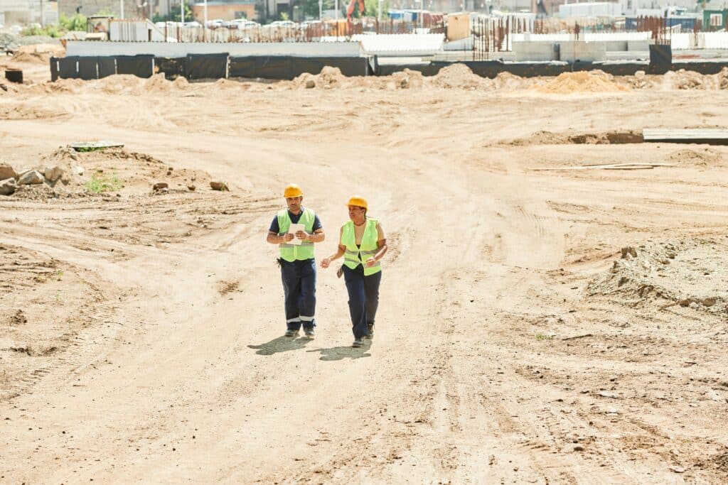 Workmen walking across a construction site