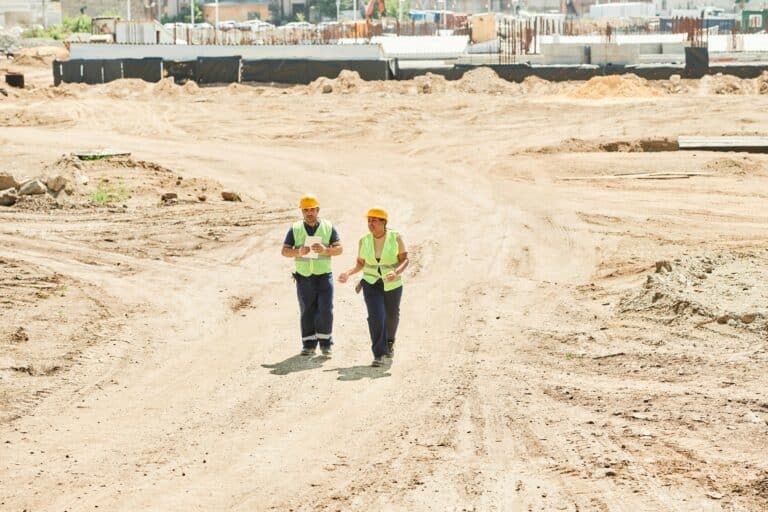 Workmen walking across a construction site