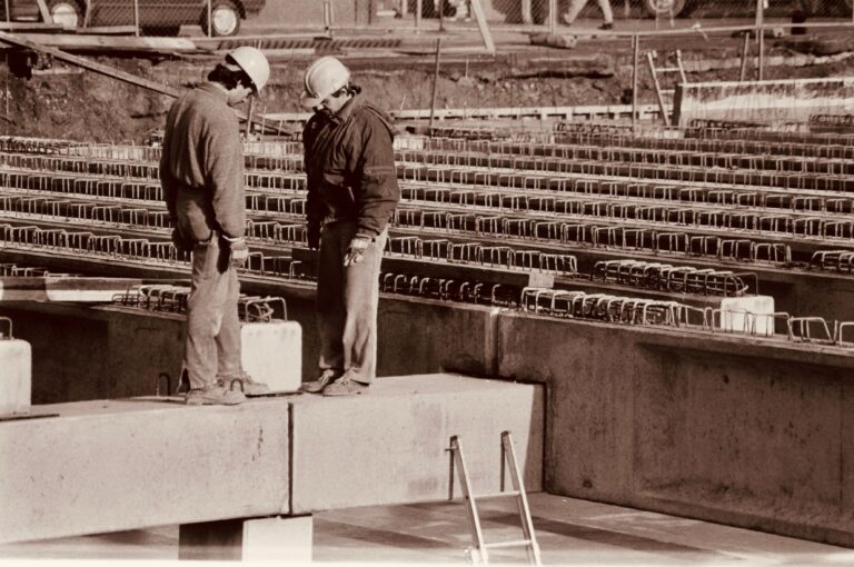 Historical construction workers image in sepia tone.